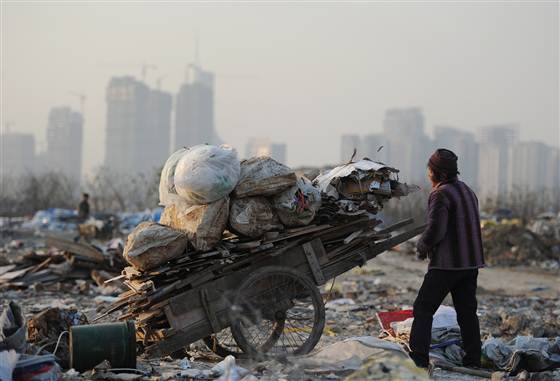 This picture taken on December 9, 2012 shows scavengers picking up useful construction waste from a garbage dump in Hefei, central China's Anhui provi...